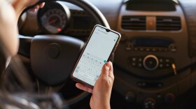 a woman using a cell phone while driving