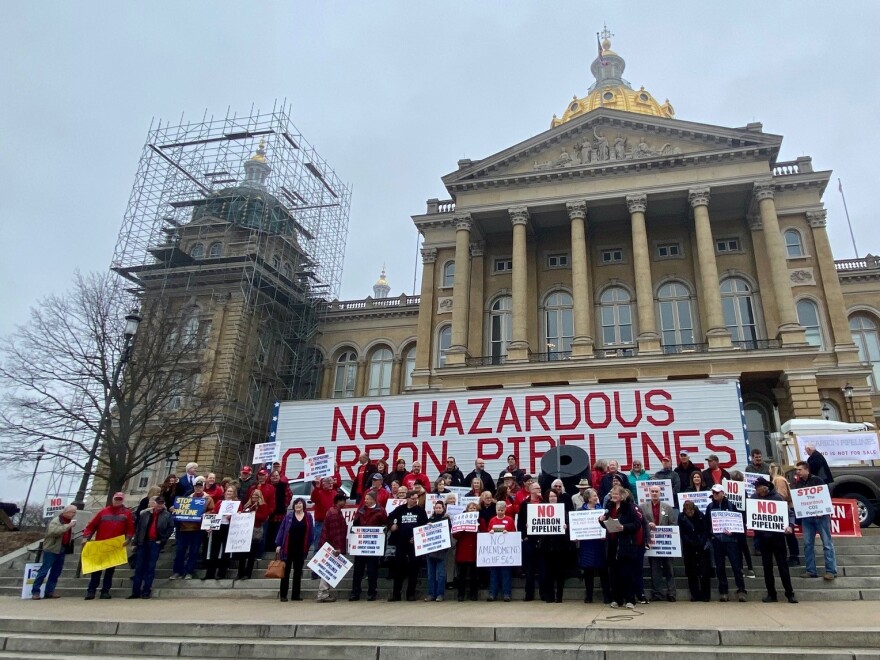 Dozens of people protesting carbon pipelines in front of iowa capitol