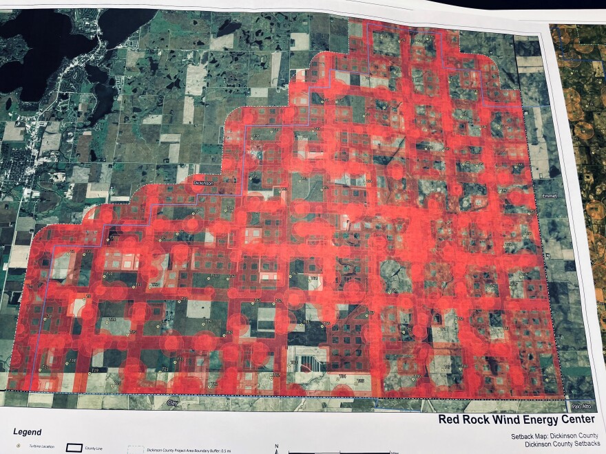 A map that shows a grid with red dots and markings and plots of green and beige.