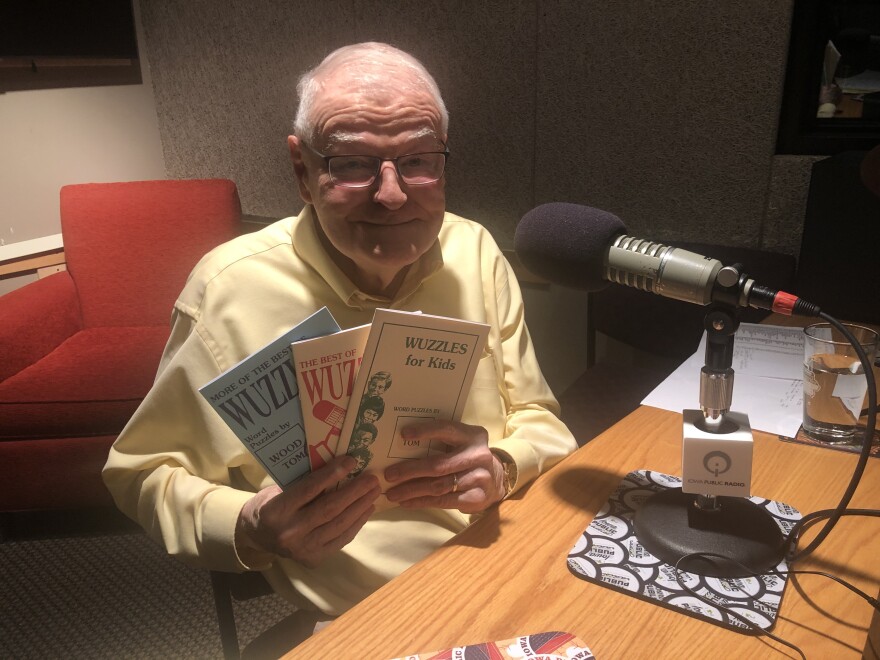 A man holds puzzle books