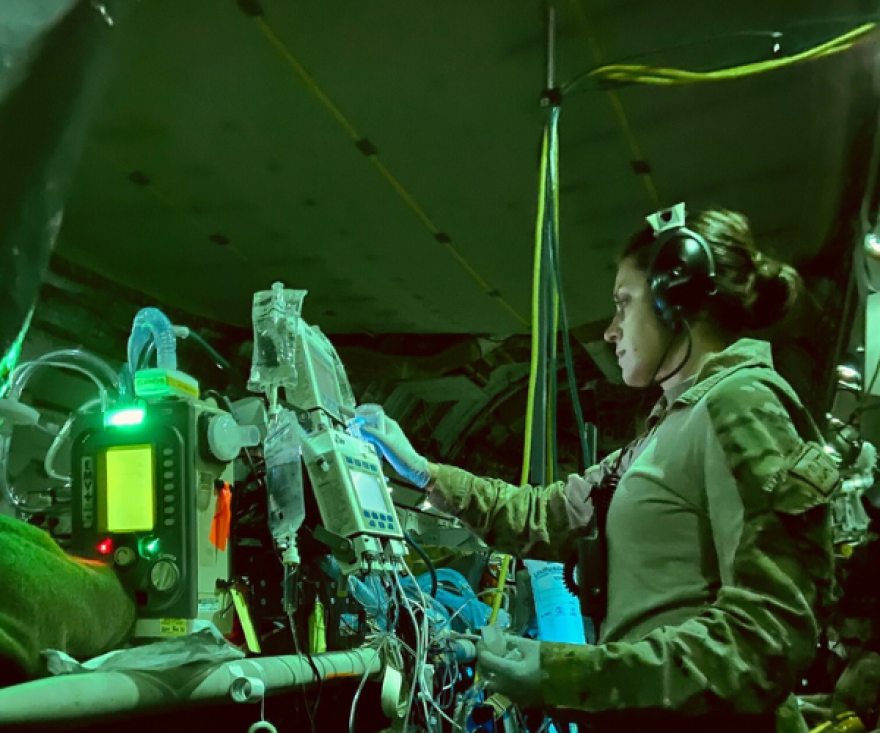  U.S. Air Force Capt. Katie Lunning, 379th Expeditionary Aeromedical Evacuation Squadron, critical care air transport team registered nurse, checks equipment on a C-17 Globemaster III in Kabul, Afghanistan.