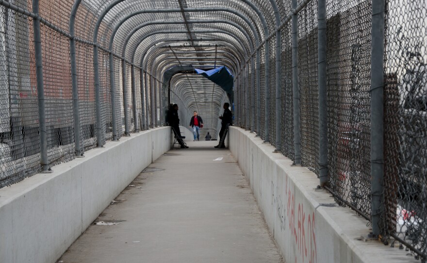 Border patrol agents wait on the U.S. side of the border on the Bridge of the Americas between El Paso, Texas and Juarez, Mexico to check identification of those crossing into the U.S. In recent months, border patrol agents have posted on the U.S. side of the border and required that migrants wait to cross due to space issues. U.S. Customs and Border Protection reported it arrested a record numbers of migrant family units in December. 