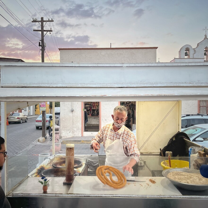 Martin Elizalde Valenzuela paints houses in the morning and is happy to sell his churros in the afternoon. The photo was taken in Jalisco, Mexico, on Dec. 26, 2022.