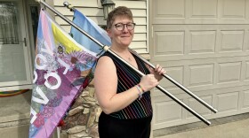 Tara McGovern holds the flags they carried in an Iowa City demonstration back in October 2023. They were acquitted for all charges related to the protest.