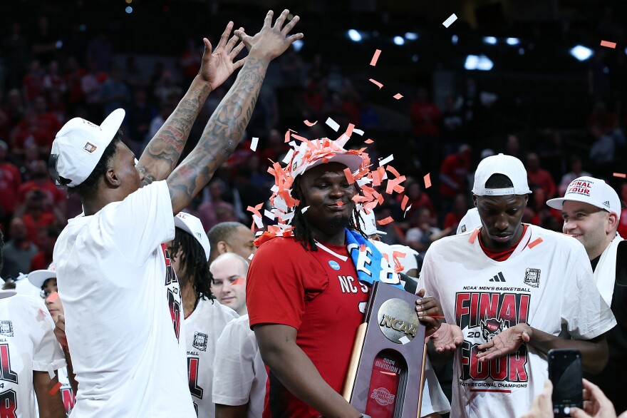 DJ Burns Jr. of the North Carolina State Wolfpack is showered with confetti after advancing to the Final Four.