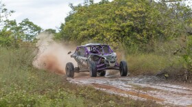 a utv drives down a muddy track