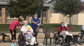 As nursing homes remain locked down indefinitely to protect residents from COVID-19, some are finding new ways for Iowans in nursing homes to see their families. Here, Mary Anne watches her family wave from a distance at the Friendship Haven retirement community in Fort Dodge in September 2020.