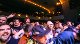 A crowd at a punk show lurches forward.