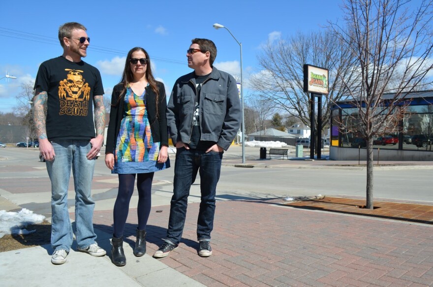  The band House of Large sizes pose for a picture outside on the College Hill street in Cedar Falls, left-to-right: Brent Hansen (drums), Barb Schilf (bass and backing vocals) and Dave Deibler (lead guitar and vocals). 