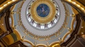 A shot of the Iowa Statehouse, looking directly upward from the ground into the golden dome