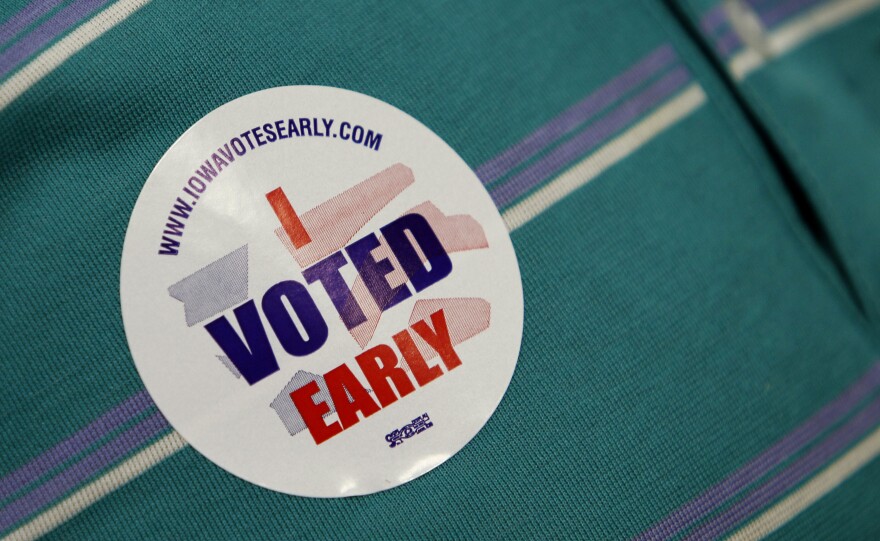 A voter wears a sticker on his shirt after casting an absentee ballot on the first day of early voting for the November general election, Thursday, Sept. 23, 2010, at the Polk County Auditors office in Des Moines, Iowa. (AP Photo/Charlie Neibergall)