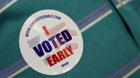 A voter wears a sticker on his shirt after casting an absentee ballot on the first day of early voting for the November general election, Thursday, Sept. 23, 2010, at the Polk County Auditors office in Des Moines, Iowa. (AP Photo/Charlie Neibergall)