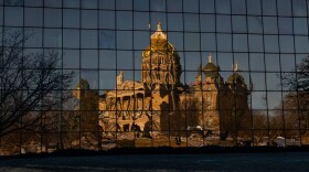 Reflection of Iowa's Capitol from the golden glass windows of the Wallace Building.