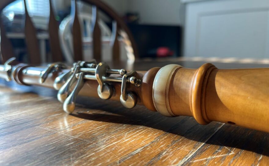 Image of beige wooden instrument on a table.