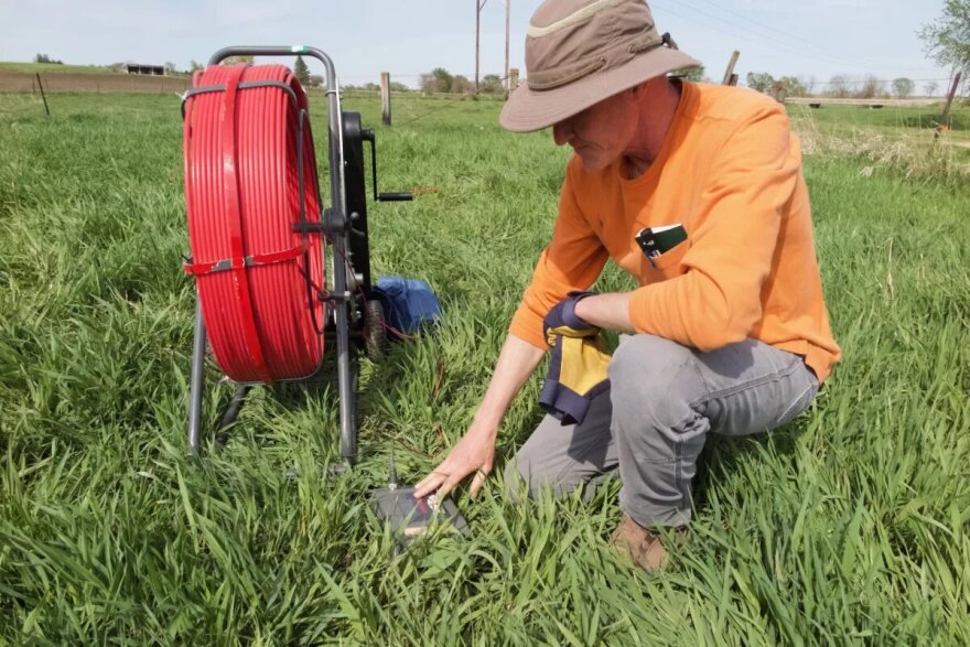 Clark Porter, environmental specialist at the Iowa Department of Agriculture and Land Stewardship, prepares an Iowa stream bank for a project to impede the flow of toxic nitrates into water.