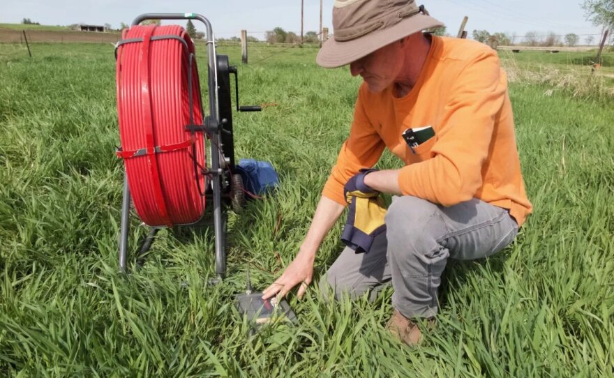 Clark Porter, environmental specialist at the Iowa Department of Agriculture and Land Stewardship, prepares an Iowa stream bank for a project to impede the flow of toxic nitrates into water.