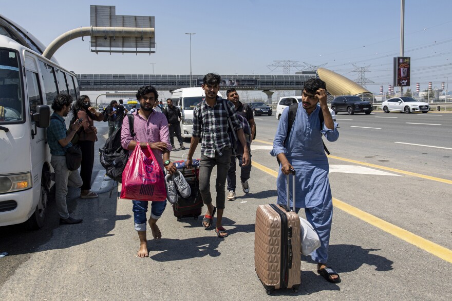 People wait for transportation on Sheikh Zayed Road in Dubai on Thursday.