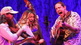 Avery Ballotta, Sasha Dubyk and Max Capistran (R-L) perform as the bluegrass trio Damn Tall Buildings.