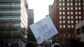 A protestor holds up a sign saying My Body My Choice