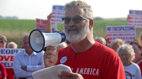 Tim Baughman of Denison speaks into a megaphone at a rally against the Summit carbon capture pipeline.