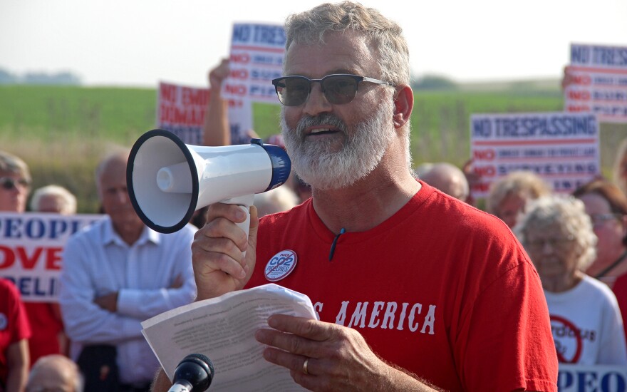 Tim Baughman of Denison speaks into a megaphone at a rally against the Summit carbon capture pipeline.