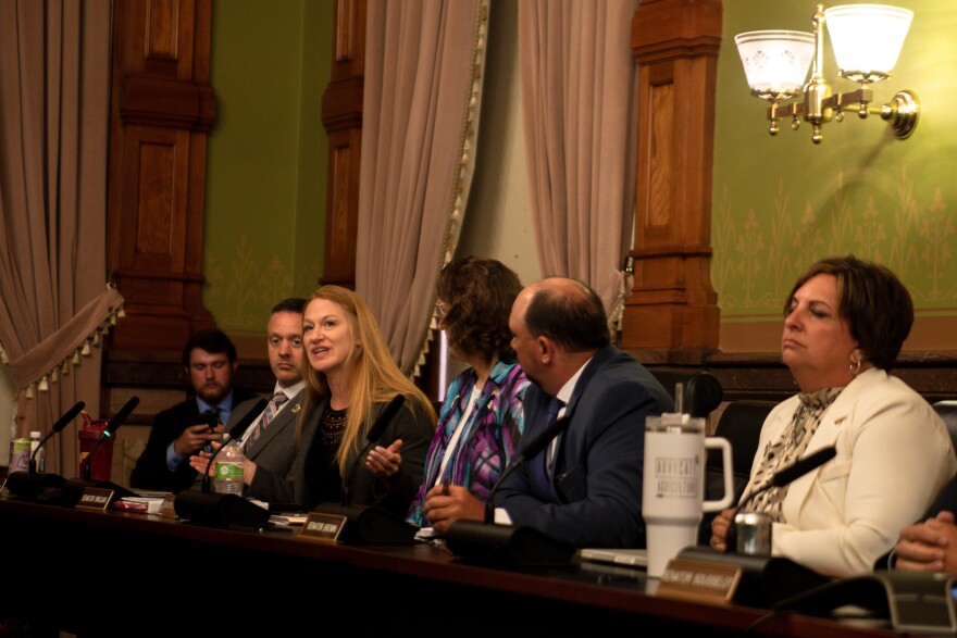 iowa senators talk in committee room at state capitol