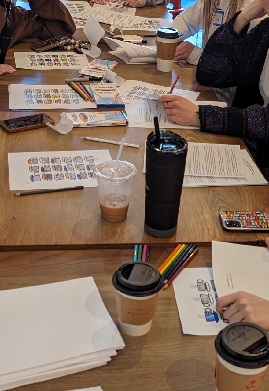 Papers, cups, pencils and coffee on a wooden table