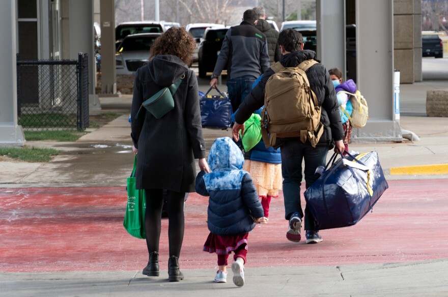 LSI team members, including Jeanna Bauer (far left), accompany an Afghan family arriving at the Des Moines International Airport in December.