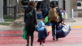 LSI team members, including Jeanna Bauer (far left), accompanies an Afghan family arriving at the Des Moines International Airport in December.