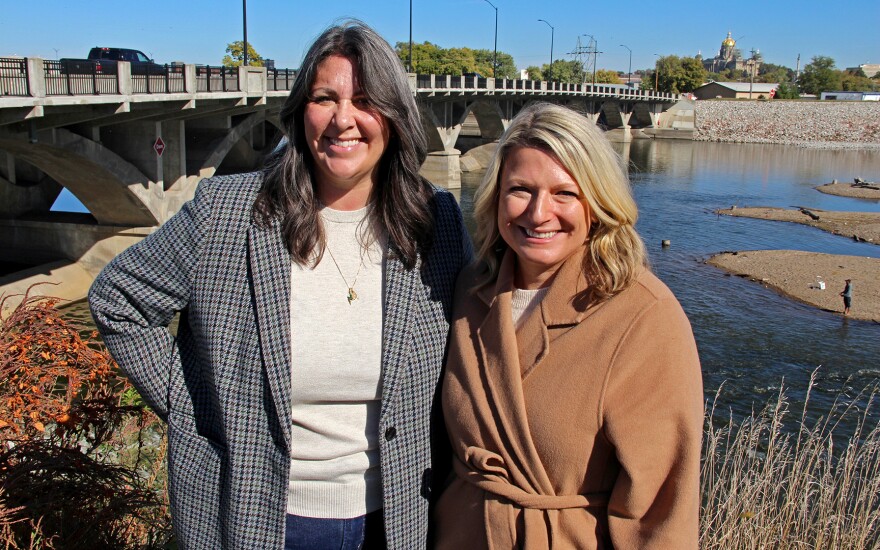 ICON Executive Director Stephanie Oppel (left) and Great Outdoors Foundation CEO Hannah Inman stand on the Des Moines River near the Scott Street dam.