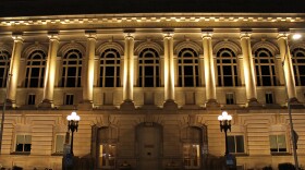 Des Moines City Hall lit up at night.