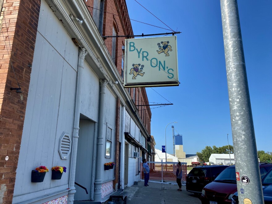 The outside of Byron's Bar has a sign with its name and dancing bears.