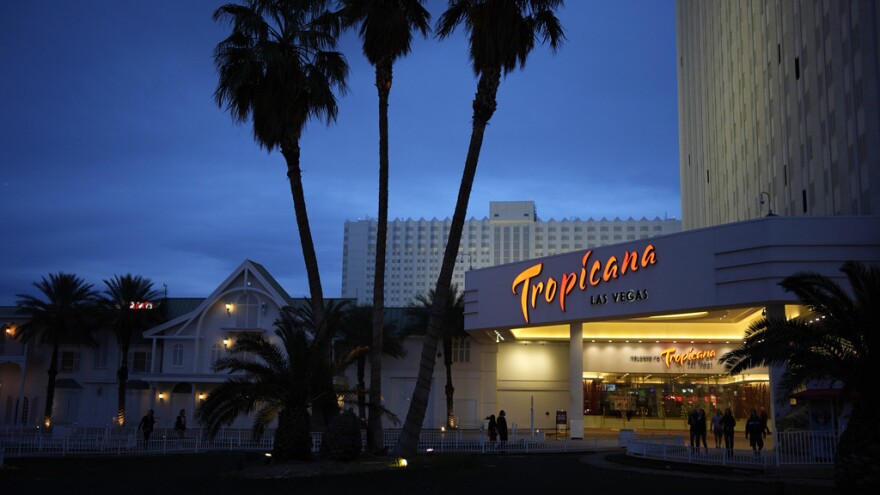 People walk outside of the Tropicana hotel-casino March 28 in Las Vegas. The property closed on Tuesday.