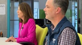 Rep. Cindy Axne and State Senator Zach Nunn sit next to each other during a debate on KMA Radio 