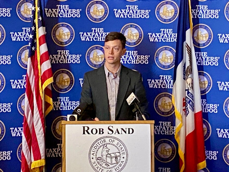 rob sand speaks at a podium