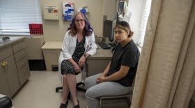 Francesca Turner (left), an OB/GYN at Broadlawns Medical Center in Des Moines, sits next to her patient Kimbrly Orea Badillo after her first postpartum appointment. Orea Badillo says she relies on Medicaid to be able to cover things like pain medication for her C-section and contraceptives following the birth of her second child in May.