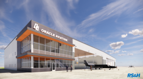 A rendering of Oracle Aviation's plan for a new flight school. It's a white and gray two-story building with an airplane hangar attached.