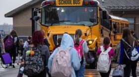 Kids attending the Ralls County School District board buses at the end of the school day on Monday, Nov. 20, 2023, in Center, Mo. While most of the district’s buses are powered by gas or diesel, it has recently added two electric school buses to its fleet. The buses were obtained via Inflation Reduction Act grants, intended to introduce electric buses to rural and high-need school districts. 