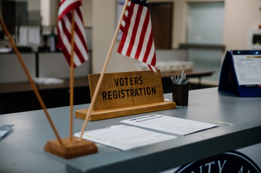  voter registration forms sit on a counter in an elections office