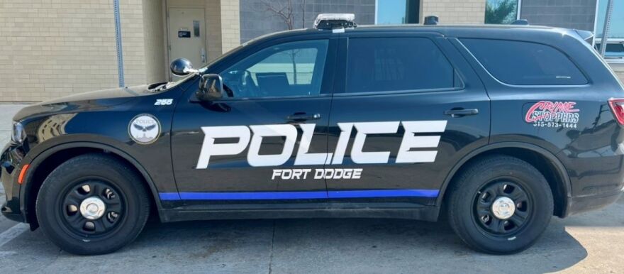 Picture of black police SUV with the words "POLICE FORT DODGE." There is a bright blue stripe under the text.