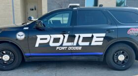 Picture of black police SUV with the words "POLICE FORT DODGE." There is a bright blue stripe under the text.