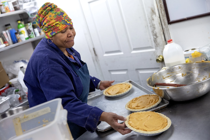 Pastry chef Carla Jones loads a trio of sweet potato pies onto a tray destined for the oven on Nov. 15 at Ol’ Henry’s Restaurant in Berkeley, Missouri. Sweet potato pie is a significant touchstone of African American culture, especially around Thanksgiving.