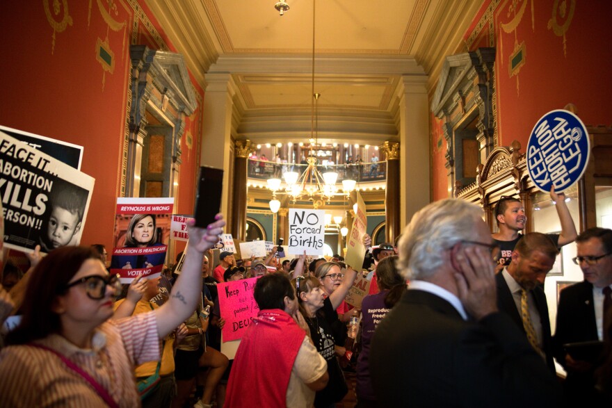 Protestors chant loudly outside the first public hearing of the special legislative session aimed at restricting abortion access in Iowa.