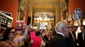 Protestors chant loudly outside the first public hearing of the special legislative session aimed at restricting abortion access in Iowa.