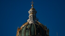 Iowa Capitol gold and green domes with a deep blue sky.