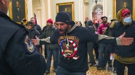 The congressional committee investigating the Jan. 6, 2021 attack on the Capitol will focus on the role of QAnon and extremist groups like the Oath Keepers and Proud Boys in its upcoming hearing. Prosecutors have identified the man at the center of this photograph as a QAnon-supporter named Douglas Jensen. Jensen has pleaded not guilty to all charges.