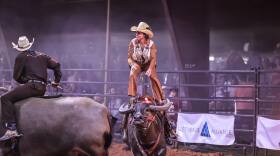 A woman wears a custom Western outfit designed by Abby Peeters to a rodeo event.