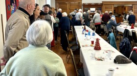 Dozens of people line up for Hotdog Friday on Dec. 22, 2023 at St. James Episcopal Church in Independence.