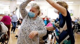 Residents and staff gather for a dance at the Ararat Nursing Facility in Los Angeles in April 2021. The pandemic exposed the dangers of inadequate staffing at nursing homes.