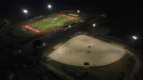 A football field, top, and baseball field under construction are lit up at Whitewater High School Friday, Oct. 1, 2021, in Whitewater, Wis. A growing number of school districts in the U.S. are using federal pandemic funding on athletics projects. When school officials in Whitewater, Wis learned they would be getting $2 million in pandemic relief this year, they decided to set most of it aside to cover costs from their current budget, freeing up $1.6 million in local funding that’s being used to build new synthetic turf fields for football, baseball and softball. (AP Photo/Morry Gash)